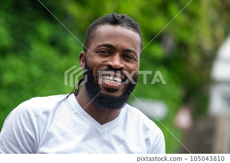 Portrait picture of a smiling dark-skinned handsome man 105043810