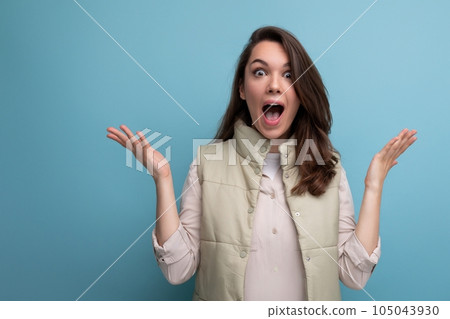 surprised caucasian young brunette woman with hair below her shoulders waving her hands in joy surprised caucasian young brunette woman with hair below her shoulders waving her hands in joy 105043930
