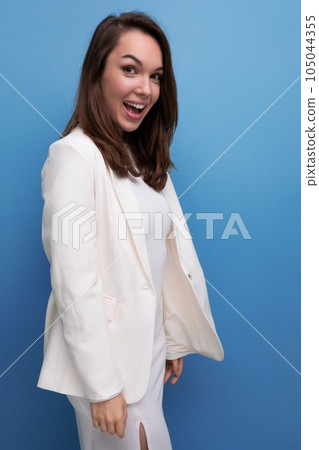 close-up portrait of caucasian brunette with long hair woman in white dress and jacket posing on close-up portrait of caucasian brunette with long hair woman in white dress and jacket posing on 105044355