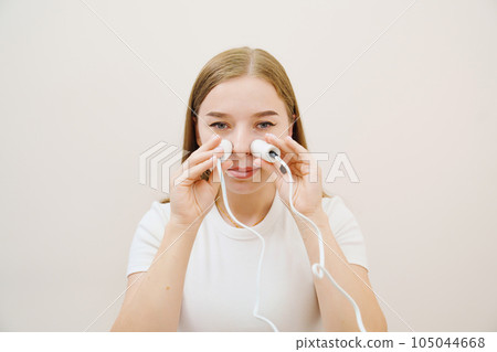 A patient on a magnetotherapy procedure on the nose A patient on a magnetotherapy procedure on the nose 105044668