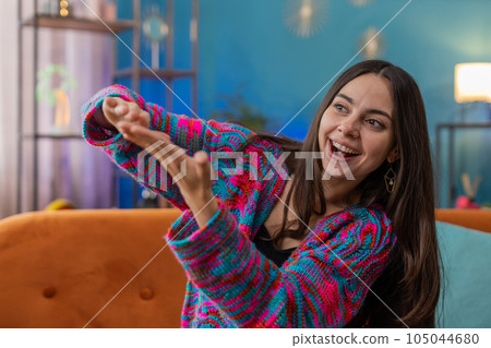 Rich happy girl showing wasting or throwing money around hand gesture, big profit win lottery, share 105044680