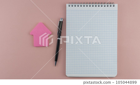blank sheet of notepad with ballpoint pen on pink background,mock up blank sheet of notepad with ballpoint pen on pink background,mock up 105044899