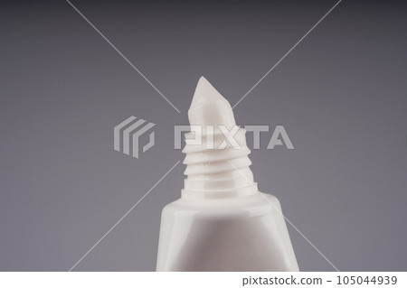 close up of a toothpaste or beauty cream tube on white background close up of a toothpaste or beauty cream tube on white background 105044939