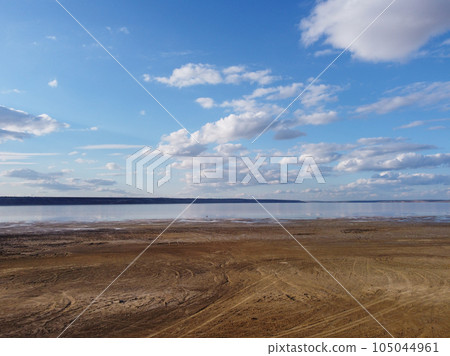 horizon,where fluffy white clouds are reflected in the calm,deep blue sea horizon,where fluffy white clouds are reflected in the calm,deep blue sea 105044961
