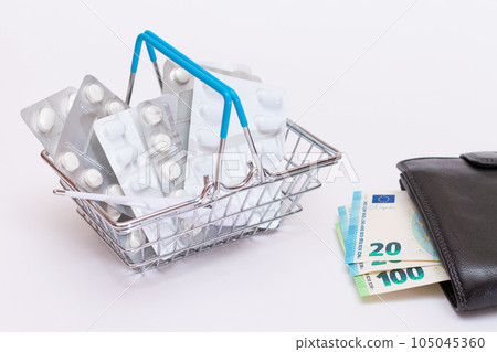 Pills and Capsules in a Shopping Basket and Black Wallet with Euro Money Pills and Capsules in a Shopping Basket and Black Wallet with Euro Money 105045360