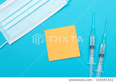 Vaccination or Revaccination Concept - Two Medical Syringe on Blue Table 105045381