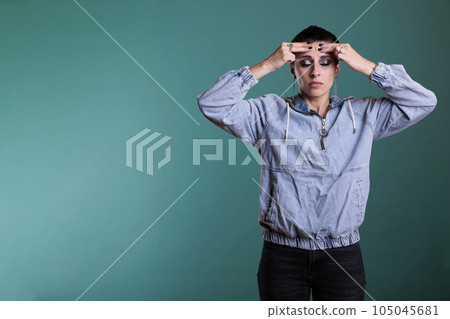 Frustrated nervous model putting hand on forehead trying not to scream after hearing the bad news during studio shot, posing over isolated background. Sad unhappy woman having displeased expression Frustrated nervous model putting hand on forehead trying not to scream after hearing the bad news during studio shot, posing over isolated background. Sad unhappy woman having displeased expression 105045681