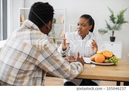 Woman with food supplements chatting with man in hospital Woman with food supplements chatting with man in hospital 105046237