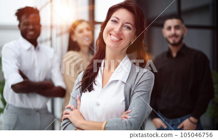 close-up of a young woman in the office on the background of colleagues 105046756
