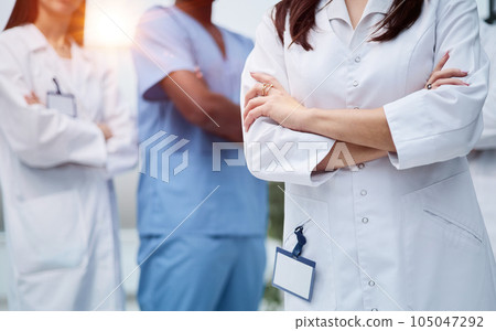 Group of medical staff in clinic hallway. Group of medical staff in clinic hallway. 105047292