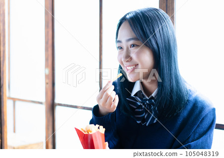 high school girl eating potato high school girl eating potato 105048319