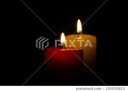 Candle flame in the darkness, hope and memory 105050823