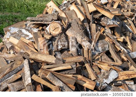 A large pile of different sawn firewood for the stove. Preparing firewood for the winter. Firewood background. 105052828