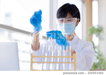 Research image Researcher looking at a test tube Research image Researcher looking at a test tube 105053393