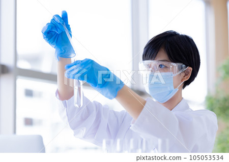 Research image Researcher looking at a test tube Research image Researcher looking at a test tube 105053534
