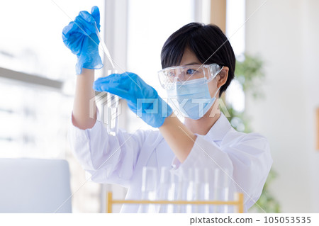 Research image Researcher looking at a test tube Research image Researcher looking at a test tube 105053535