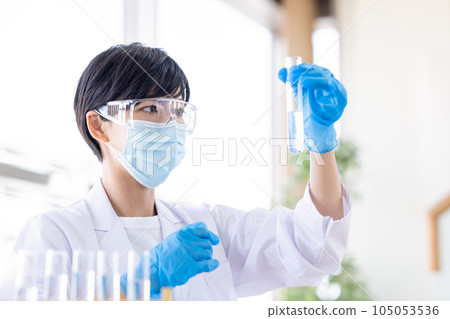 Research image Researcher looking at a test tube Research image Researcher looking at a test tube 105053536