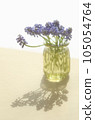 Muscari flowers <flowers in the image of spring in a bottle on the table by the window> 105054764