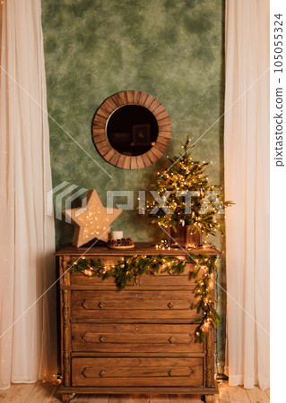 Antique wooden brown chest of drawers with Christmas decor Antique wooden brown chest of drawers with Christmas decor 105055324
