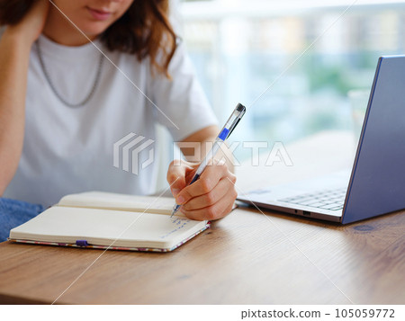 woman using laptop while working indoors woman using laptop while working indoors 105059772