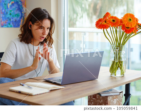 woman using laptop while working indoors woman using laptop while working indoors 105059841