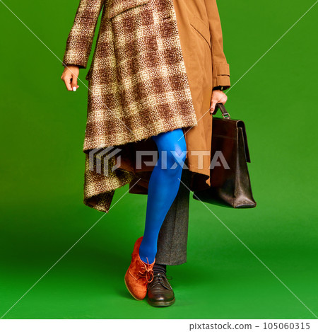 Man and woman wearing warm color in retro style against green studio background. Autumn style Man and woman wearing warm color in retro style against green studio background. Autumn style 105060315
