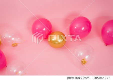 Group of multicolored transparent, pink and gold balloons lying on the floor in the house for Valentine's Day, Birthday, holiday concept Group of multicolored transparent, pink and gold balloons lying on the floor in the house for Valentine's Day, Birthday, holiday concept 105064272