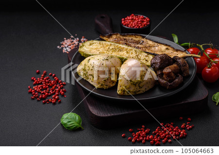 Delicious grilled vegetables zucchini, eggplant, peppers and mushrooms with salt, spices and herbs 105064663
