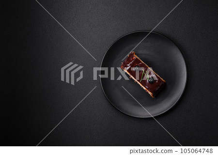 Delicious sweet dessert cheesecake with candied fruits in chocolate Delicious sweet dessert cheesecake with candied fruits in chocolate 105064748