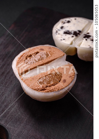 Delicious sweet mochi dessert with toppings on a dark concrete background 105065053