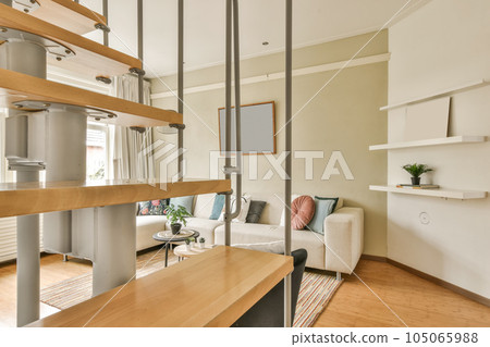 a living room with wood flooring and white walls, including an open staircase leading up to the second floor a living room with wood flooring and white walls, including an open staircase leading up to the second floor 105065988