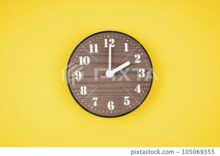 The Retro wooden clock at 2 O' clock on yellow color background. 105069355
