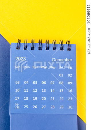 The December 2023 Monthly desk calendar for 2023 year on blue and yellow background. The December 2023 Monthly desk calendar for 2023 year on blue and yellow background. 105069411