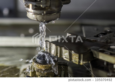 Closeup scene the wire EDM machine cutting the mold insert parts. 105070492