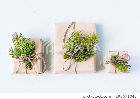 Christmas composition of a gift boxes with Christmas tree branches. Concept of New year and Christmas, flat lay Christmas composition of a gift boxes with Christmas tree branches. Concept of New year and Christmas, flat lay 105071045