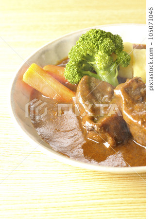 Hot beef stew with thickly sliced beef tongue, garnished with broccoli, carrots and potatoes 105071046