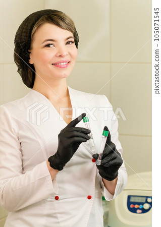osmetologist holds test tube with blood 105071545