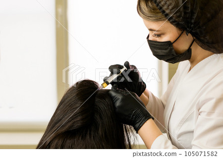 osmetologist holds test tube with blood 105071582