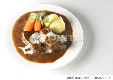 Watercress, carrots, potatoes and hot cream-covered thick-sliced beef tongue over a white background 105071693