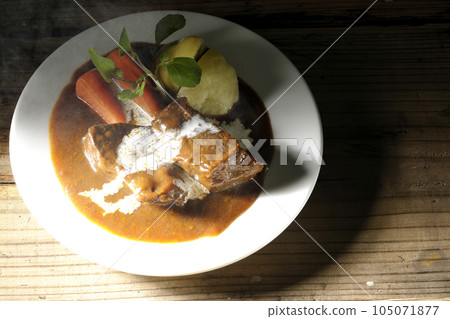 A bird's-eye view of hot beef stew with watercress, carrots, potatoes and thick-sliced beef tongue covered with fresh cream A bird's-eye view of hot beef stew with watercress, carrots, potatoes and thick-sliced beef tongue covered with fresh cream 105071877