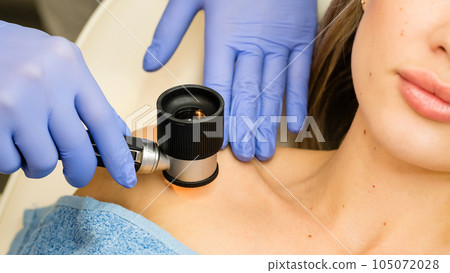 Dermatologist examines moles and birthmarks Dermatologist examines moles and birthmarks 105072028
