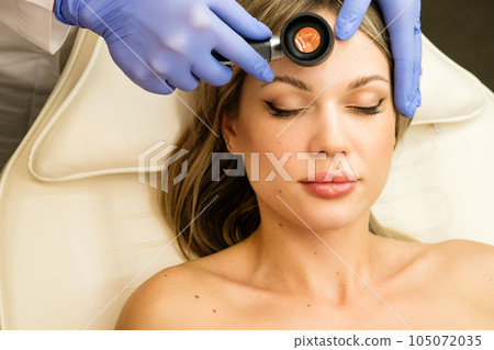 Dermatologist examines moles and birthmarks Dermatologist examines moles and birthmarks 105072035