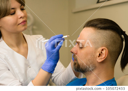 Marking face man before anti-aging treatment Marking face man before anti-aging treatment 105072433