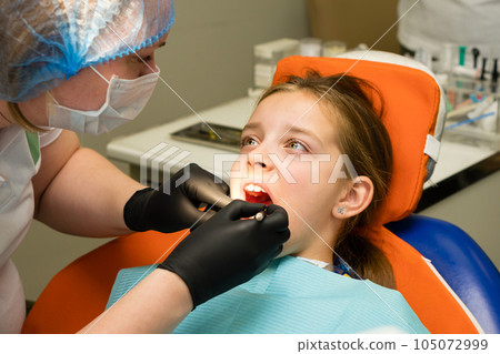 Girl on dental appointment. Regular check up teeth 105072999
