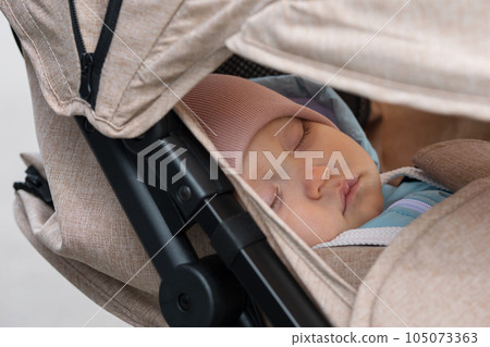 Toddler girl falls asleep during walking in city park 105073363