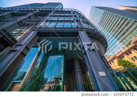 Tokyo cityscape in Japan July. Intense heat... View of Tokyo Station reflected in the glass windows of Marunouchi, Tokyo, and the Shin-Marunouchi Building Tokyo cityscape in Japan July. Intense heat... View of Tokyo Station reflected in the glass windows of Marunouchi, Tokyo, and the Shin-Marunouchi Building 105073772