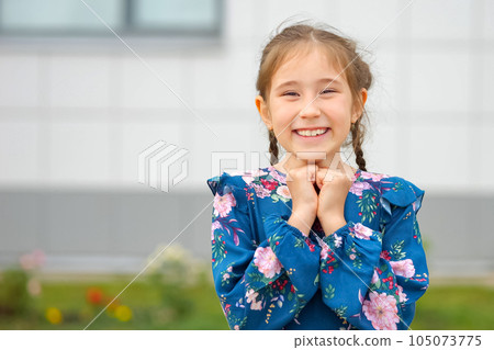 Junior school girl in flowery dress rejoices at school camp 105073775