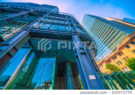 Tokyo cityscape in Japan July. Intense heat... View of Tokyo Station reflected in the glass windows of Marunouchi, Tokyo, and the Shin-Marunouchi Building Tokyo cityscape in Japan July. Intense heat... View of Tokyo Station reflected in the glass windows of Marunouchi, Tokyo, and the Shin-Marunouchi Building 105073778
