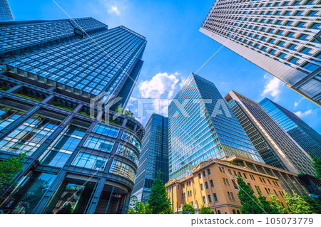 Tokyo cityscape in Japan July. Intense heat... View of Tokyo Station reflected in the glass windows of Marunouchi, Tokyo, and the Shin-Marunouchi Building Tokyo cityscape in Japan July. Intense heat... View of Tokyo Station reflected in the glass windows of Marunouchi, Tokyo, and the Shin-Marunouchi Building 105073779