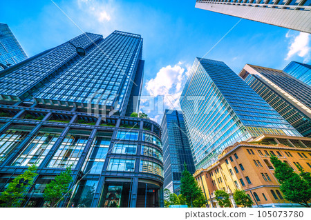 Tokyo cityscape in Japan July. Intense heat... View of Tokyo Station reflected in the glass windows of Marunouchi, Tokyo, and the Shin-Marunouchi Building Tokyo cityscape in Japan July. Intense heat... View of Tokyo Station reflected in the glass windows of Marunouchi, Tokyo, and the Shin-Marunouchi Building 105073780